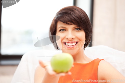 Image of lovely housewife with green apple
