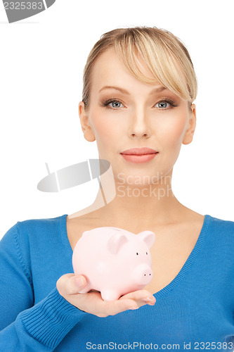 Image of lovely woman with piggy bank