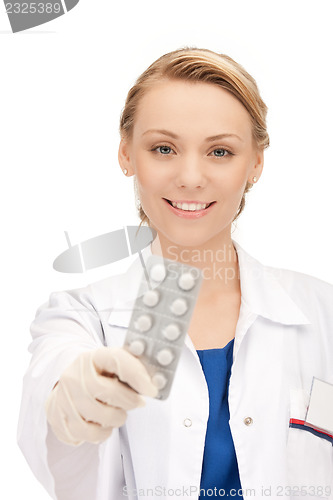 Image of attractive female doctor with pills