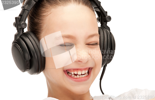 Image of happy teenage girl in big headphones