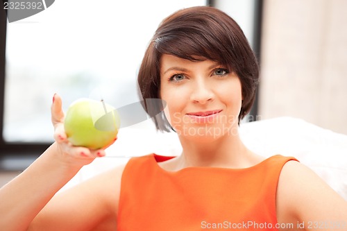 Image of lovely housewife with green apple