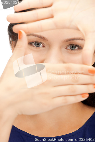 Image of lovely woman creating a frame with fingers