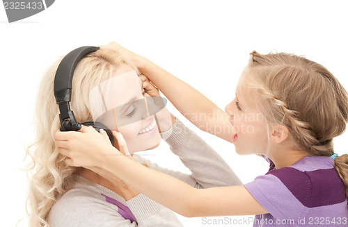 Image of mother and little girl with headphones