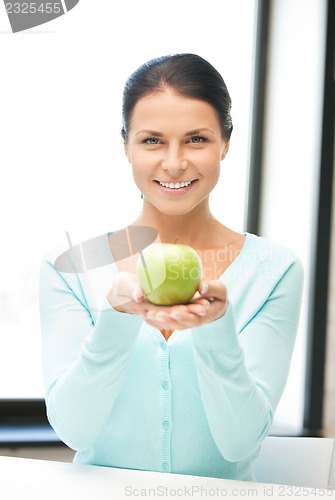 Image of lovely housewife with green apple