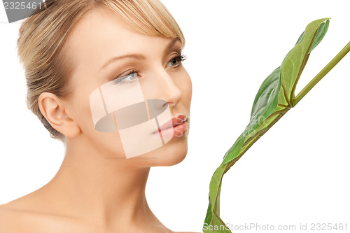 Image of woman with green leaf