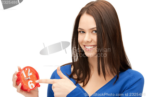 Image of woman holding alarm clock