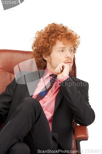 Image of young businessman sitting in chair