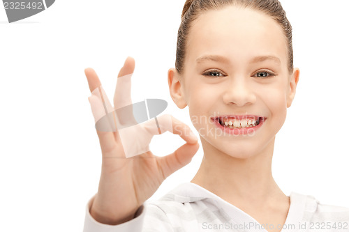 Image of lovely teenage girl showing ok sign