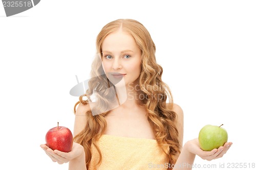 Image of young beautiful woman with green and red apples
