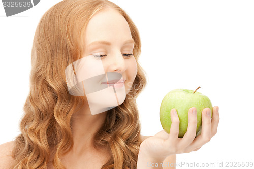 Image of young beautiful woman with green apple