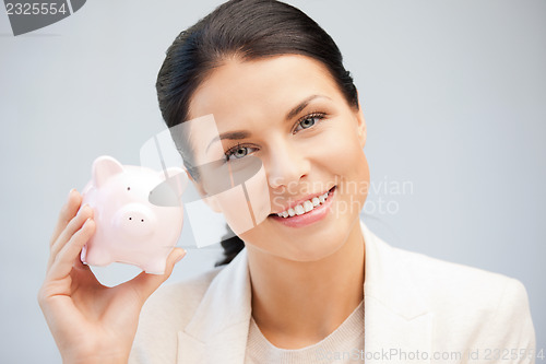 Image of lovely woman with piggy bank