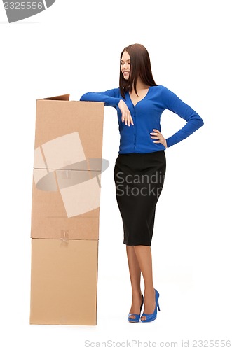 Image of attractive businesswoman with big boxes