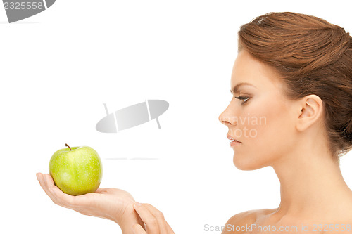 Image of young beautiful woman with green apple