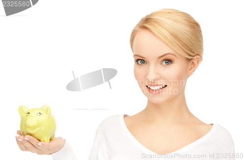 Image of lovely woman with piggy bank