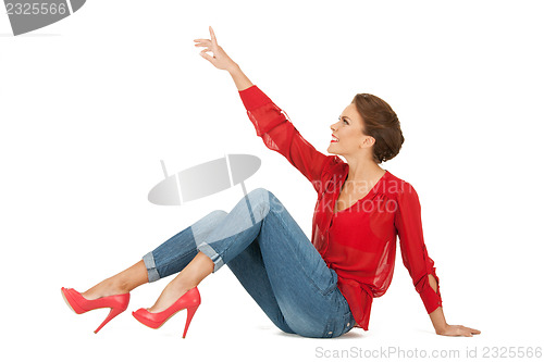 Image of lovely woman in red blouse and jeans