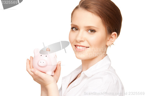 Image of lovely woman with piggy bank