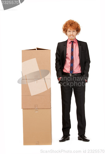 Image of attractive businessman with big boxes