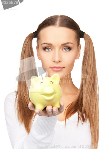 Image of lovely woman with piggy bank