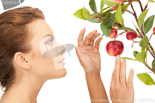 Image of lovely woman with apple twig