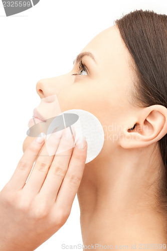 Image of beautiful woman with cotton pad