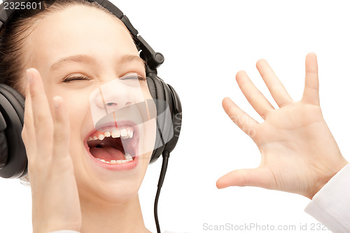 Image of happy teenage girl in big headphones