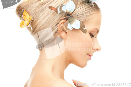 Image of beautiful woman with butterfly in hair
