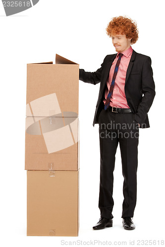 Image of attractive businessman with big boxes