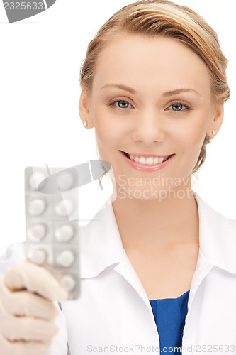 Image of attractive female doctor with pills