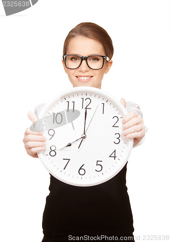 Image of woman holding big clock