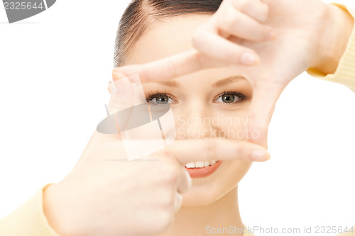 Image of lovely woman creating a frame with fingers