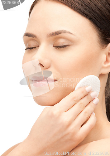 Image of beautiful woman with cotton pad