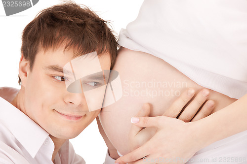 Image of male face and pregnant woman belly