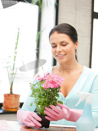 Image of lovely housewife with flower