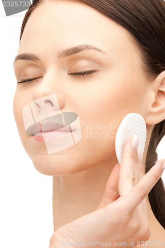 Image of beautiful woman with cotton pad