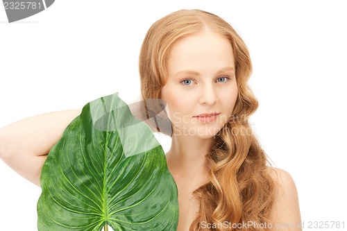Image of woman with green leaf