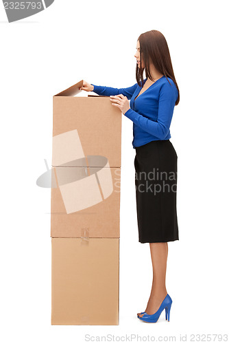 Image of attractive businesswoman with big boxes