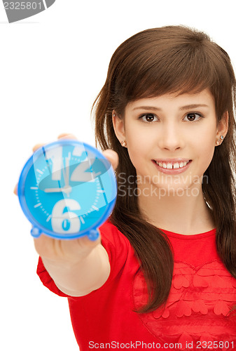 Image of teenage girl holding alarm clock