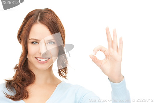 Image of lovely teenage girl showing ok sign