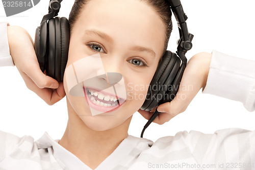 Image of happy teenage girl in big headphones