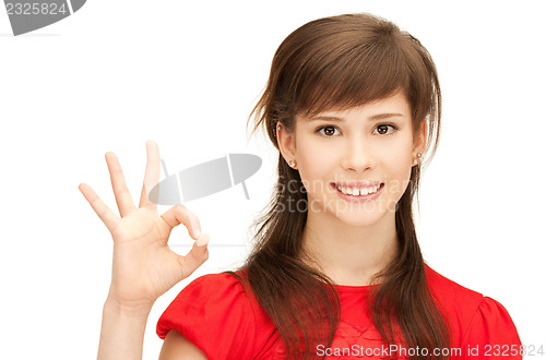 Image of lovely teenage girl showing ok sign