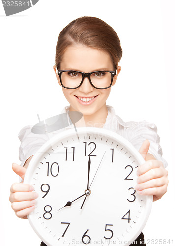 Image of woman holding big clock