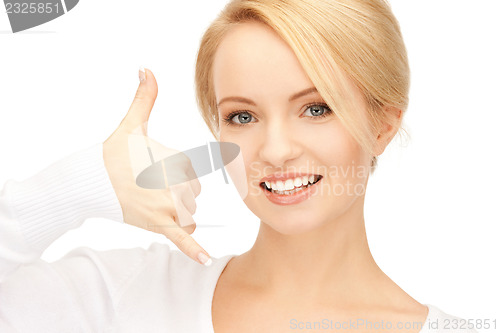Image of woman making a call me gesture