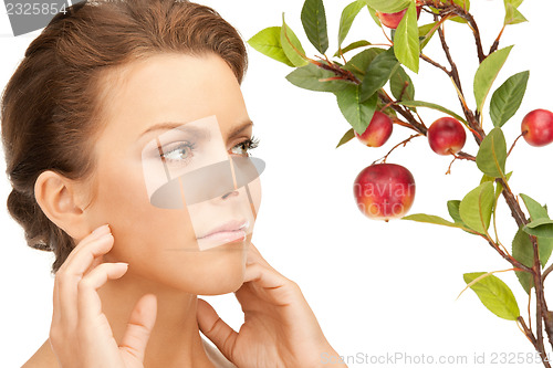 Image of lovely woman with apple twig