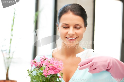 Image of lovely housewife with flower