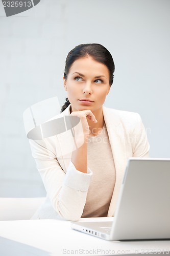 Image of pensive woman with laptop computer