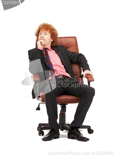 Image of young businessman sitting in chair