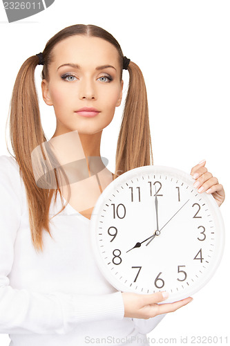 Image of woman holding big clock