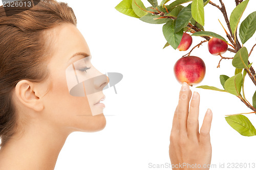 Image of lovely woman with apple twig