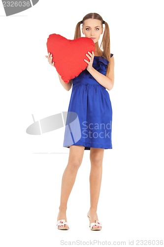 Image of lovely woman with red heart-shaped pillow
