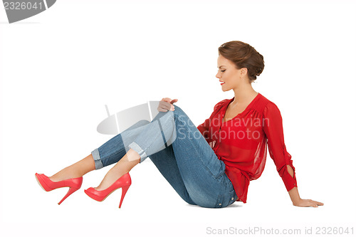 Image of lovely woman in red blouse and jeans